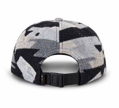 Rear view of a cap with a black, gray, and beige abstract pattern, featuring a black adjustable strap and plastic buckle.